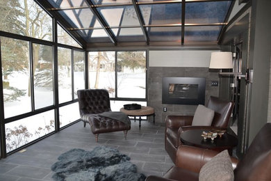 Inspiration for a large transitional ceramic tile and gray floor sunroom remodel in Detroit with a ribbon fireplace, a tile fireplace and a skylight