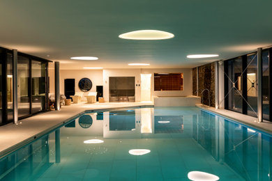 Photo of a large contemporary swimming pool in Surrey.