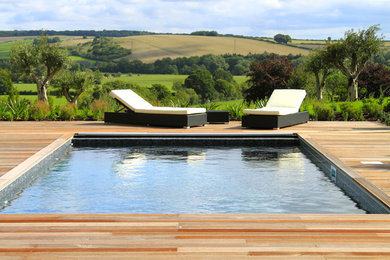 Inspiration for a large rural back swimming pool in Dorset with decking.