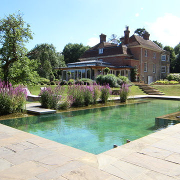 Beautiful stone tiled natural swimming pool