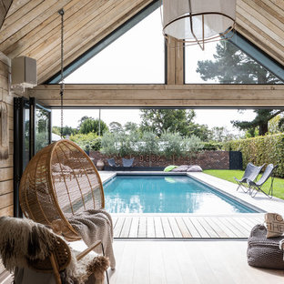 Beach style back rectangular lengths swimming pool in Sussex with decking.