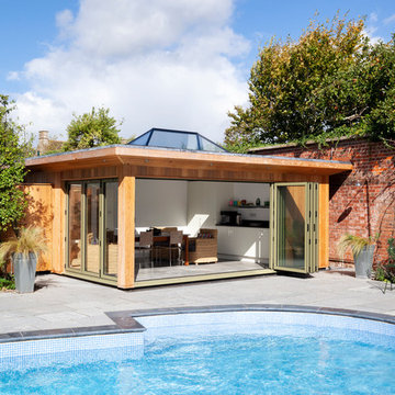 Contemporary pool house amongst a traditional setting.
