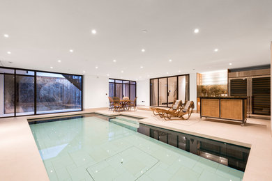Design ideas for a medium sized contemporary indoor rectangular lengths swimming pool in London.