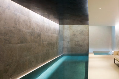 This is an example of a large contemporary indoor rectangular lengths swimming pool in London.