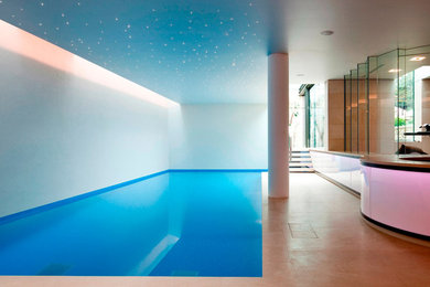 Immagine di una piscina coperta naturale moderna rettangolare di medie dimensioni con piastrelle