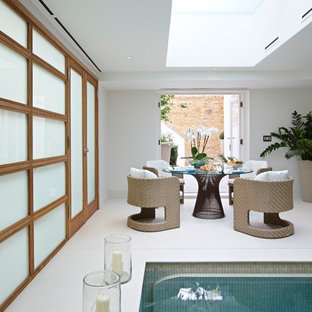 This is an example of a contemporary indoor swimming pool in London with a pool house.