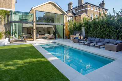 This is an example of a medium sized contemporary back rectangular lengths swimming pool in London.