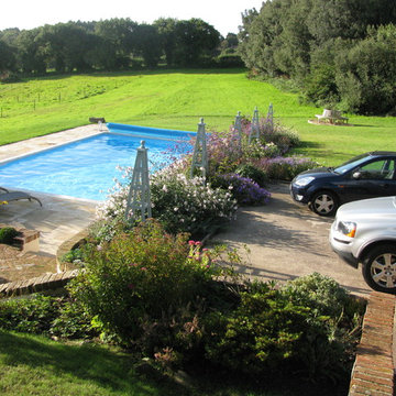 Pool with planting to the north and east with views to France to the south