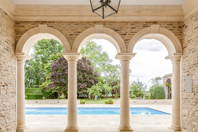 Inspiration for a classic rectangular swimming pool in Gloucestershire with a pool house and natural stone paving.
