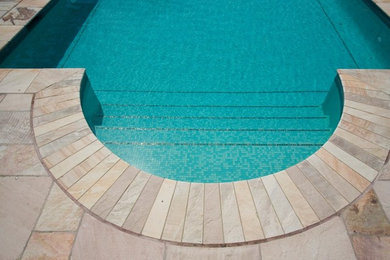 Design ideas for a large mediterranean rectangular lengths swimming pool in Other with natural stone paving.