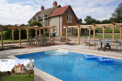 Inspiration for a traditional swimming pool in Wiltshire with natural stone paving.