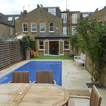 Swimming fool and refurbished garden with full extended house in background