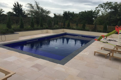 This is an example of a beach style swimming pool in Sussex.