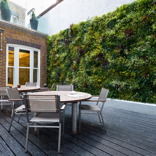 Deck - large traditional courtyard deck idea in Surrey