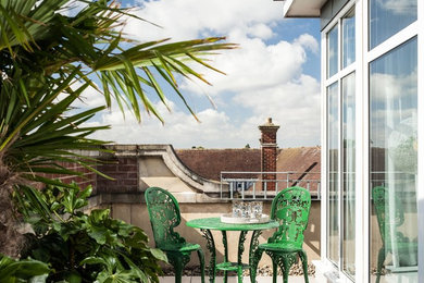 This is an example of a medium sized contemporary roof terrace in Other with a potted garden and no cover.