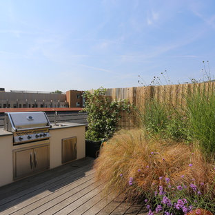 Photo of a medium sized contemporary roof rooftop terrace in London with an outdoor kitchen and no cover.