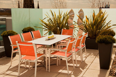 This is an example of an expansive modern roof terrace in London with no cover.