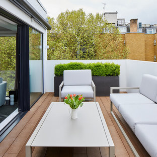 This is an example of a medium sized contemporary terrace in London with a potted garden and no cover.