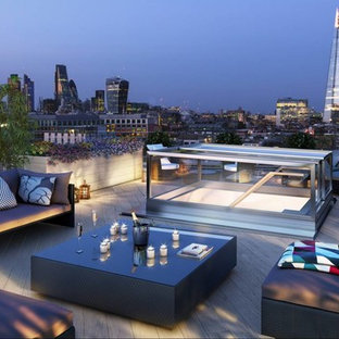 Photo of a medium sized contemporary roof rooftop terrace in London with a potted garden and no cover.