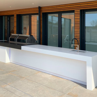 Large trendy courtyard outdoor kitchen deck photo in Essen