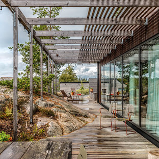 Inspiration för en mellanstor minimalistisk terrass på baksidan av huset, med en pergola