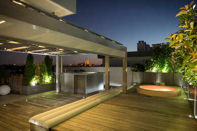 Diseño de terraza actual de tamaño medio en azotea con jardín de macetas y pérgola