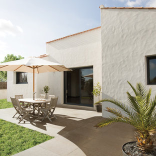 Inspiration pour une terrasse avec des plantes en pots arrière méditerranéenne de taille moyenne avec du carrelage et aucune couverture.