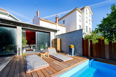 This is an example of a medium sized contemporary back terrace in Lyon with no cover.