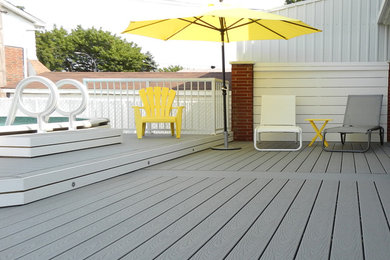 Patio - mid-sized contemporary backyard patio idea in Montreal with decking