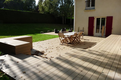 This is an example of a medium sized modern back ground level terrace in Paris with no cover.