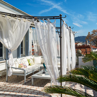 Idée de décoration pour une terrasse latérale méditerranéenne avec une pergola.