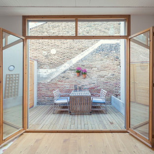 This is an example of a small urban back terrace in Barcelona with a potted garden and no cover.
