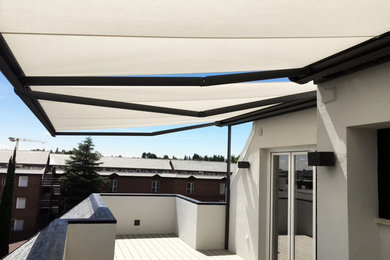 Large scandinavian side terrace in Madrid with an awning.