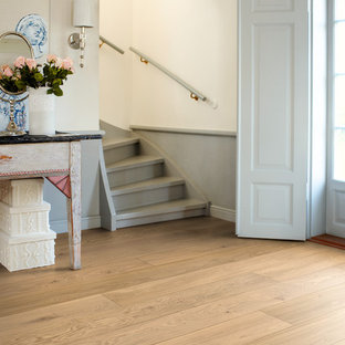 Inspiration for a mid-sized shabby-chic style painted u-shaped staircase remodel in Other with painted risers