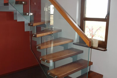 Inspiration för en stor funkis svängd trappa i målat trä, med öppna sättsteg