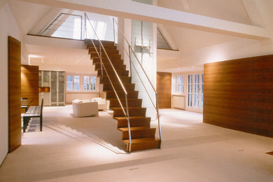 Inspiration for a large contemporary wood staircase in Nuremberg with feature lighting.