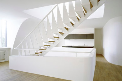 Inspiration for a large contemporary wood straight staircase in Munich with open risers.