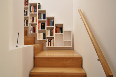 This is an example of a contemporary wood curved staircase in Frankfurt with wood risers.