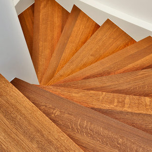 Diseño de escalera curva, contemporánea, pequeña, con escalones de madera, contrahuellas de madera y barandilla de madera