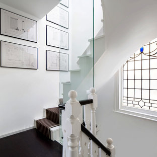 Design ideas for a medium sized contemporary painted wood curved wood railing staircase in London with painted wood risers.