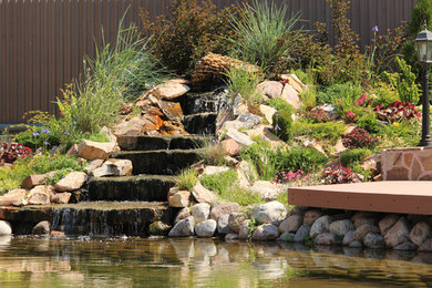 Diseño de jardín contemporáneo grande en patio con estanque, exposición total al sol y entablado
