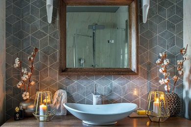 Пример оригинального дизайна: ванная комната в современном стиле с плоскими фасадами, темными деревянными фасадами, серой плиткой, настольной раковиной, столешницей из дерева, коричневой столешницей, серыми стенами и душем с распашными дверями