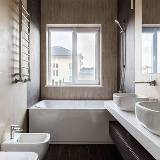 Small contemporary master bathroom in Moscow with flat-panel cabinets, dark wood cabinets, an alcove tub, a bidet, beige tile, porcelain tile, porcelain floors, engineered quartz benchtops, brown floor, white benchtops and a vessel sink.
