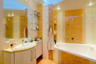 This is an example of a medium sized contemporary ensuite bathroom in Other with white cabinets, a submerged bath, an alcove shower, a wall mounted toilet, multi-coloured tiles, mosaic tiles, ceramic flooring, a submerged sink and solid surface worktops.