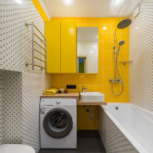 Photo of a contemporary master bathroom in Saint Petersburg with a shower/bathtub combo, a wall-mount toilet, white tile, yellow tile, a vessel sink, wood benchtops, grey floor, an open shower, brown benchtops, open cabinets and an alcove tub.