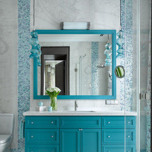 This is an example of a contemporary bathroom in Moscow with recessed-panel cabinets, turquoise cabinets, an undermount sink, grey floor, white benchtops and a single vanity.