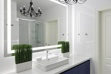 Пример оригинального дизайна: ванная комната среднего размера в современном стиле с душем в нише, инсталляцией, белой плиткой, белыми стенами, полом из керамогранита, врезной раковиной, столешницей из искусственного камня, белым полом, душем с раздвижными дверями и белой столешницей