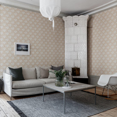 Living room - mid-sized scandinavian light wood floor and beige floor living room idea in Stockholm with multicolored walls and a corner fireplace