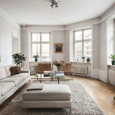 Large danish formal and open concept medium tone wood floor living room photo in Stockholm with gray walls and no tv