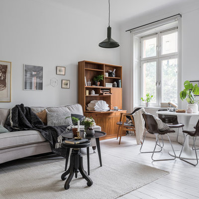 Inspiration for a mid-sized scandinavian formal and open concept painted wood floor living room remodel in Stockholm with white walls and no tv